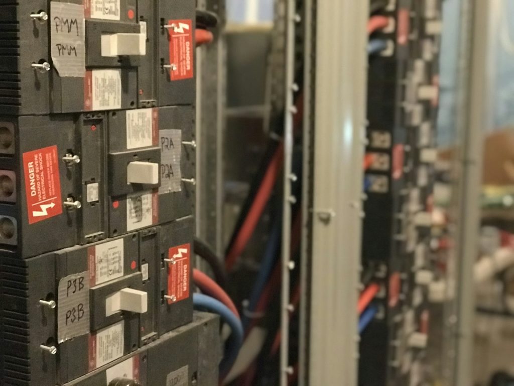 Commercial panelboard with bolt-on breakers and hand-labelled circuits
