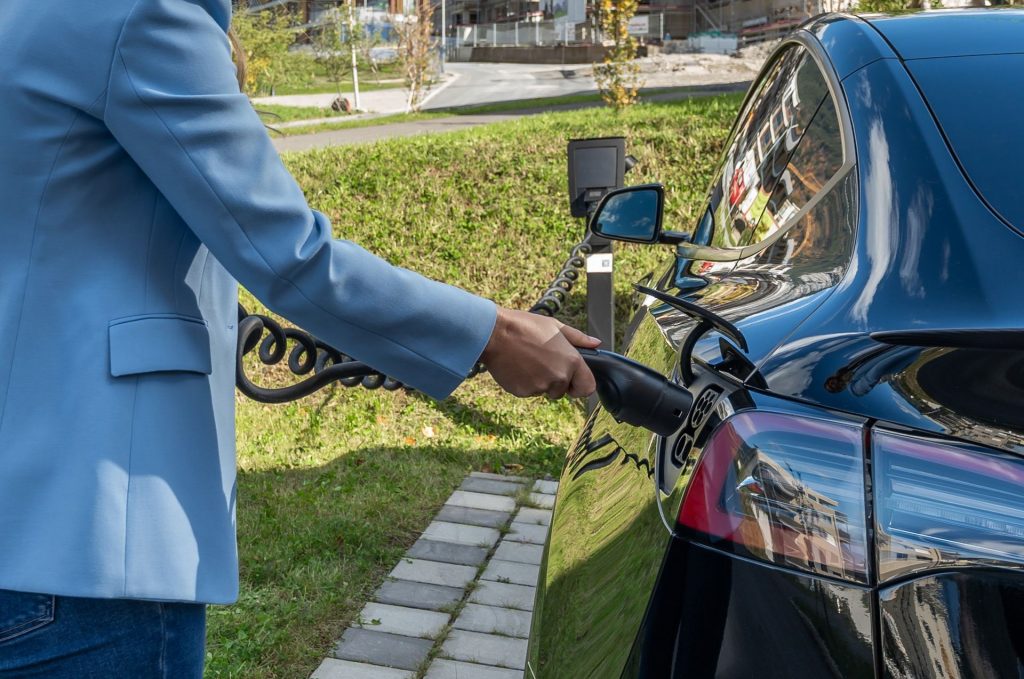 Charging cable being plugged into an electric car at a home