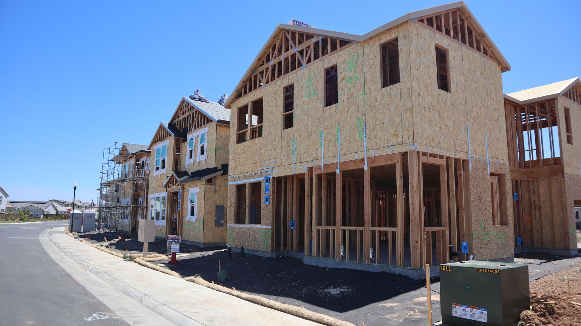 New houses under construction along a residential street